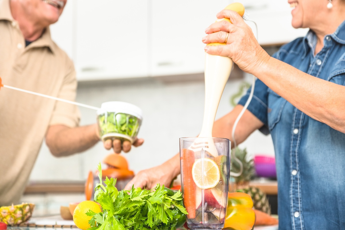 Senior couple having fun in kitchen with healthy food - debunking nutrition myths